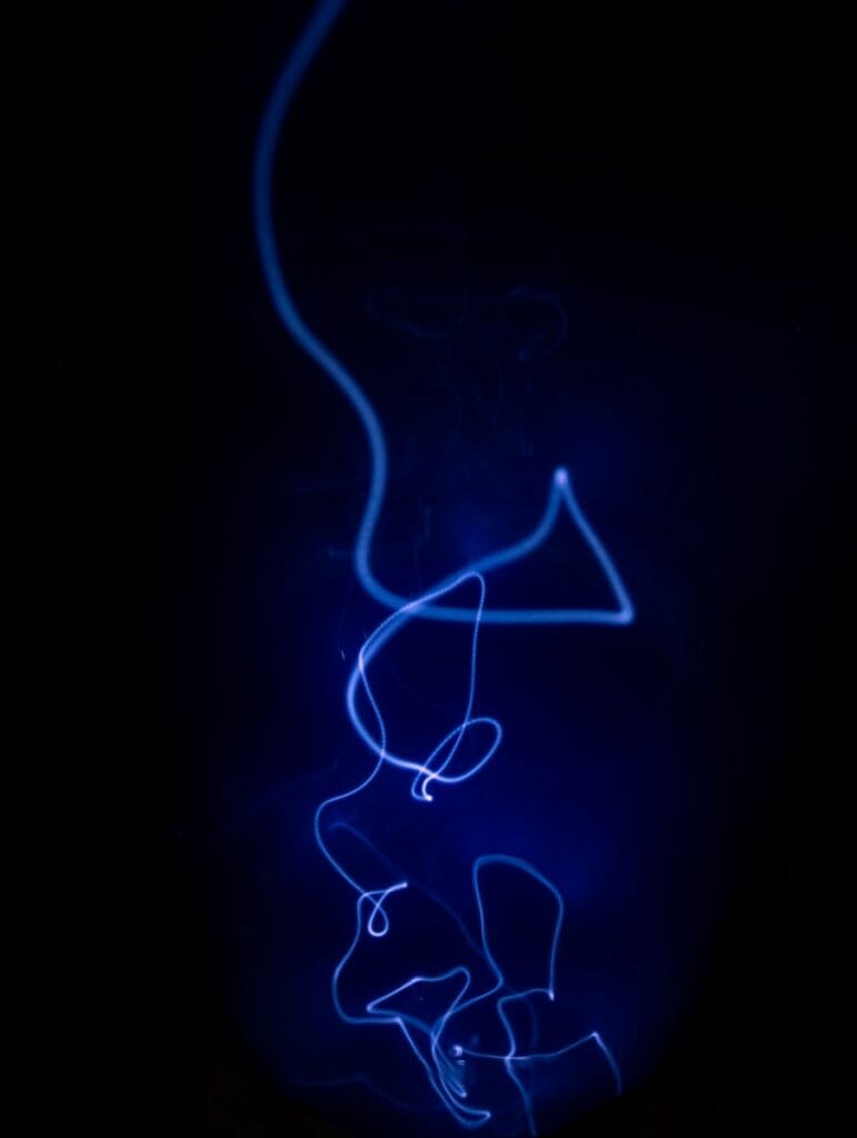a blue light is shining on a black background